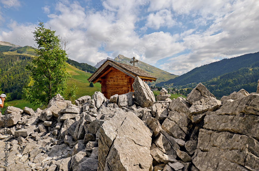 Small wooden church in the mountains with rocky view. Alps. France Small wooden church in the mountains with rocky view. Alps. France
