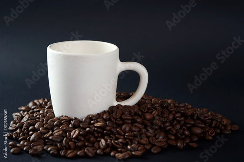 A Cup of coffee among coffee beans
