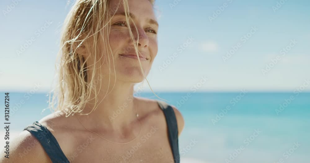 Portrait of attractive young woman smiling at the beach, happy healthy blonde woman radiating wellness and life Portrait of attractive young woman smiling at the beach, happy healthy blonde woman radiating wellness and life