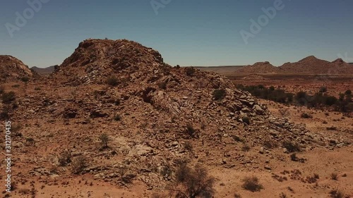 4K aerial drone video of gravel plains and granite rock formations near town Karasburg, B1 highway in the south of Namibia and dry waterless hot bush savanna in Grunau District, southern Africa photo