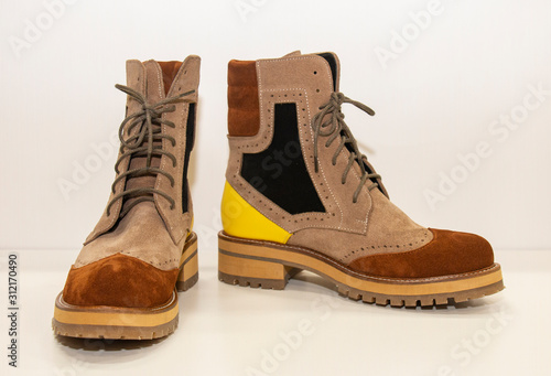 women's suede boots with yellow accents on a white background
