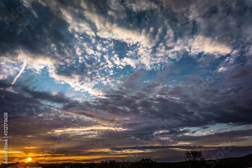 fiery sunset under cloudy skies