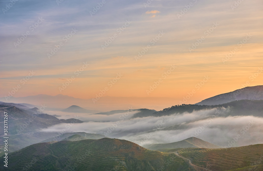 Beautiful Sunrise over Clouds and Mountains