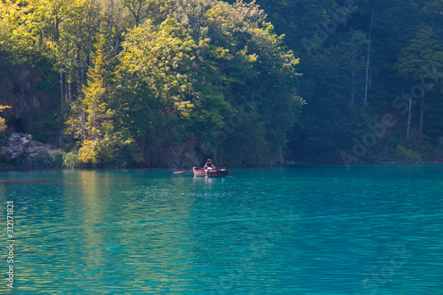 boat with people on a lake in the National Park Plitvice Lakes, Croatia
