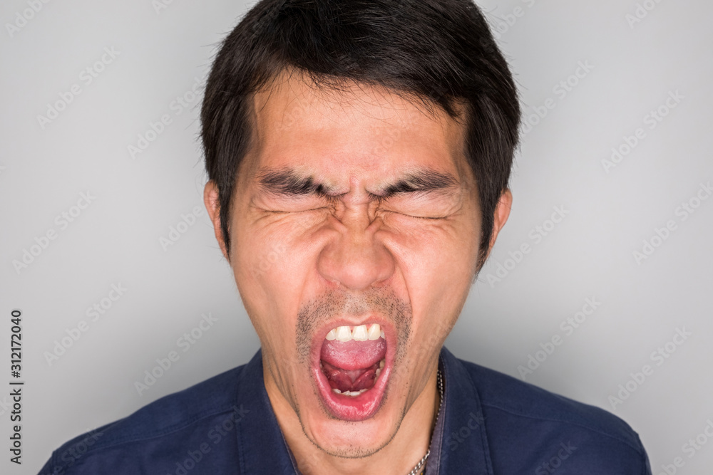 a handsome man in angry feeling. angry is negative feeling. he is screaming, shouting a handsome man in angry feeling. angry is negative feeling. he is screaming, shouting