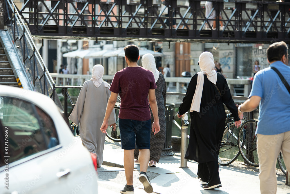 Obraz premium Muslims strolling the streets of Europe. Religious diversity.