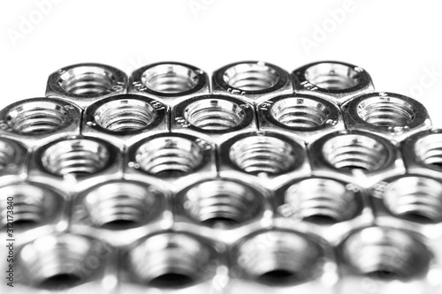 Metal nuts in a row background. Chromed screw nuts isolated. Steel nuts pattern. Set of Nuts and bolts. Tools for work. Black and white