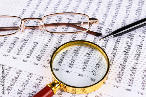 Financial concept. Calculator  pen and glasses on financial documents. Financial accounting. Balance sheets. Closeup of financial statements and annual reports. Business marketing