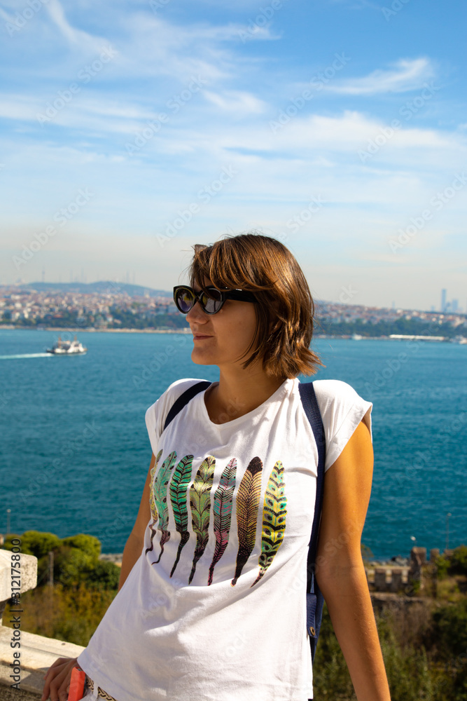 Beautitiful woman traveller standing at the view point to Bosphorus bay in Istanbul Turkey.