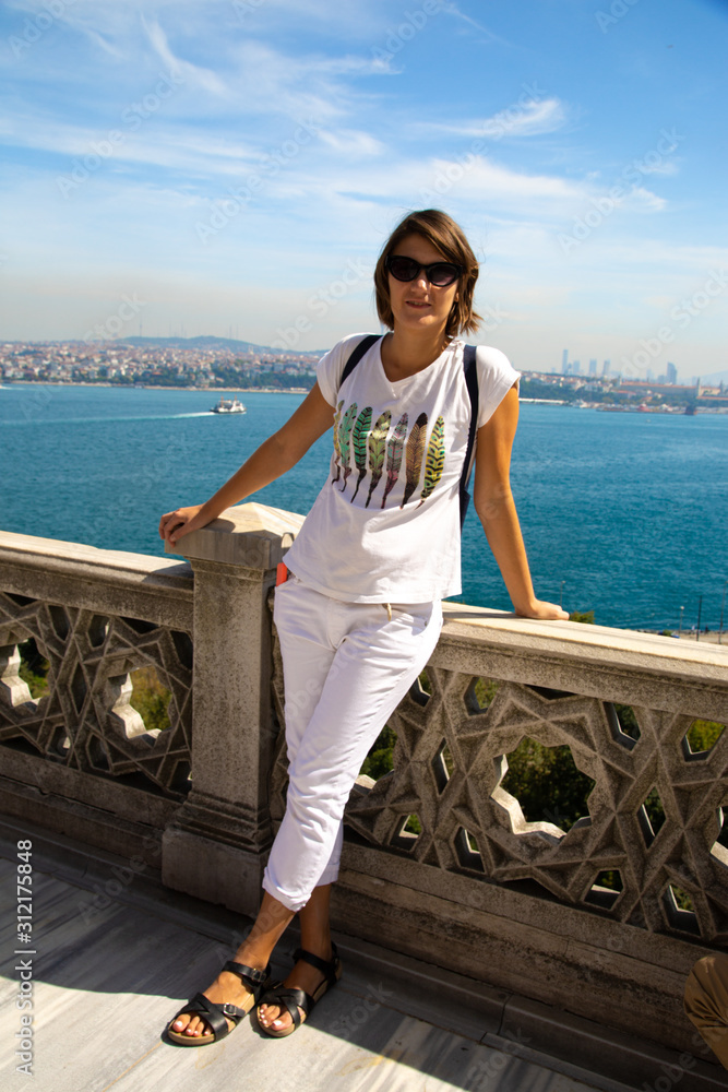 Beautitiful woman traveller standing at the view point to Bosphorus bay in Istanbul Turkey.