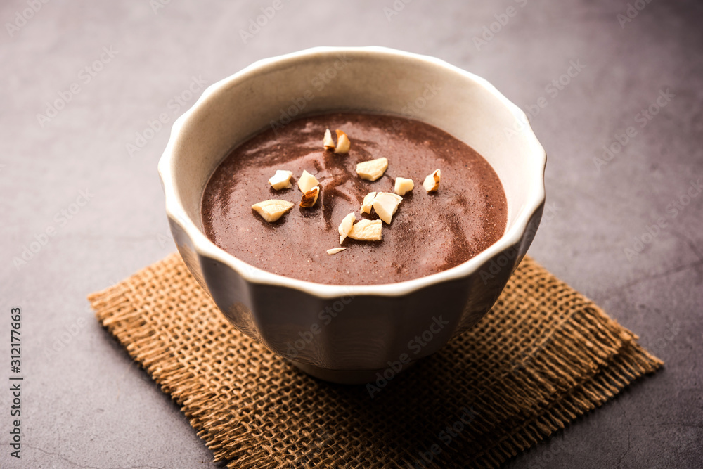 Sweet Ragi Malt / Healthy Ragi Porridge in a bowl garnished with crushed dry fruits Sweet Ragi Malt / Healthy Ragi Porridge in a bowl garnished with crushed dry fruits