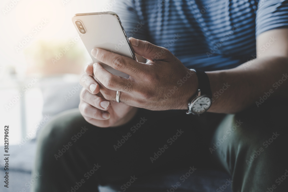 using cell phone.hand holding texting message on screen mobile chatting friend ,search internet information sitting on sofa in office.technology device contact communication connecting people concept using cell phone.hand holding texting message on screen mobile chatting friend ,search internet information sitting on sofa in office.technology device contact communication connecting people concept