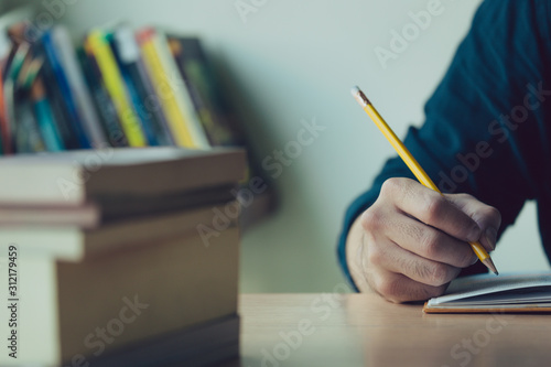 high school,university student study.hands holding pencil writing paper answer sheet.sitting lecture chair taking final exam 