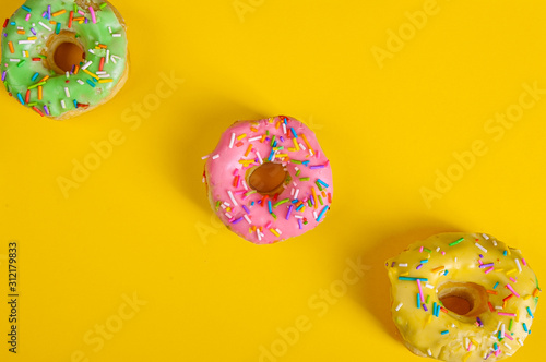 colorful doughnuts yellow background studio