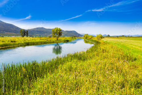 Croatia, beautiful scenic landscape, Gacka river among grass banks in Lika region