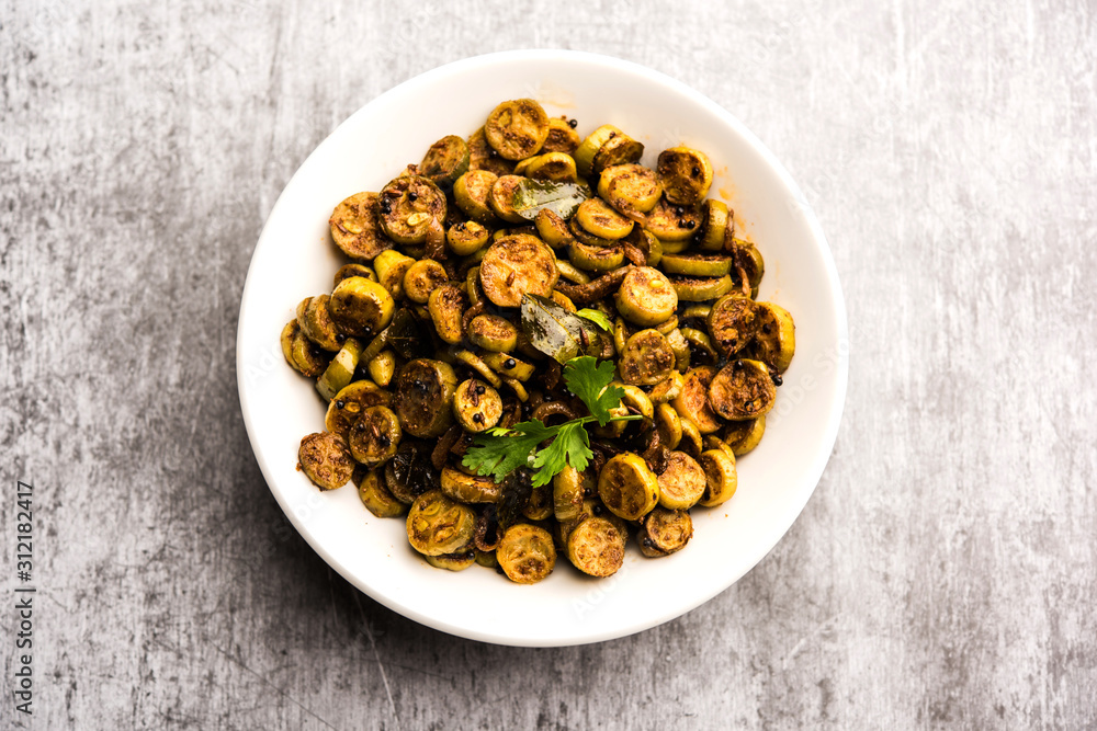 Tendli / Kundroo sabzi or Kovakkai Poriyal also known as ivy gourd, served in a bowl or karahi. selective focus Tendli / Kundroo sabzi or Kovakkai Poriyal also known as ivy gourd, served in a bowl or karahi. selective focus
