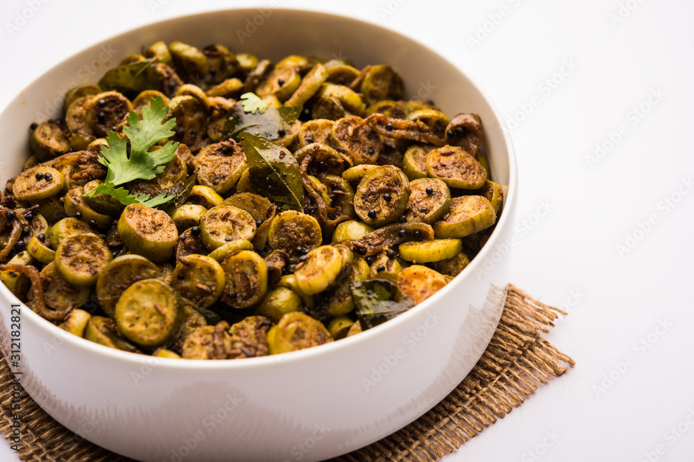 Tendli / Kundroo sabzi or Kovakkai Poriyal also known as ivy gourd, served in a bowl or karahi. selective focus Tendli / Kundroo sabzi or Kovakkai Poriyal also known as ivy gourd, served in a bowl or karahi. selective focus