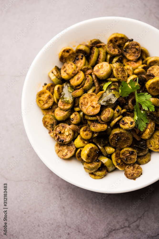 Tendli / Kundroo sabzi or Kovakkai Poriyal also known as ivy gourd, served in a bowl or karahi. selective focus Tendli / Kundroo sabzi or Kovakkai Poriyal also known as ivy gourd, served in a bowl or karahi. selective focus
