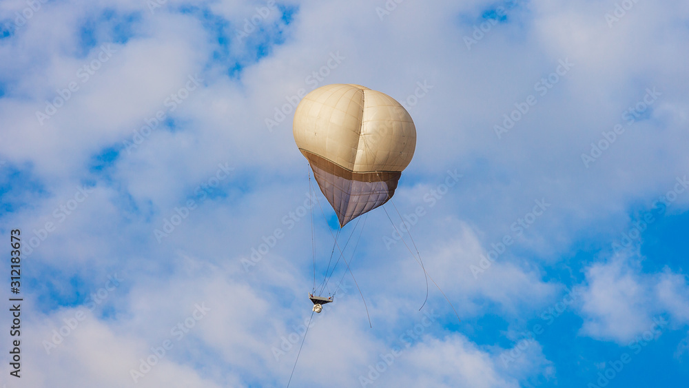 Fototapeta premium White military balloon in a white clouds