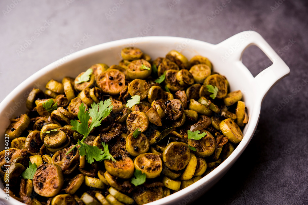 Tendli / Kundroo sabzi or Kovakkai Poriyal also known as ivy gourd, served in a bowl or karahi. selective focus Tendli / Kundroo sabzi or Kovakkai Poriyal also known as ivy gourd, served in a bowl or karahi. selective focus