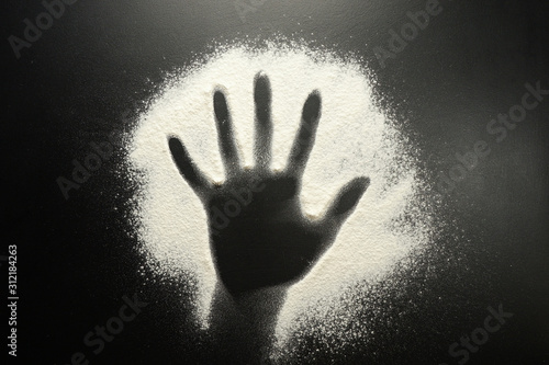 Drawing flour on a black board. Palm