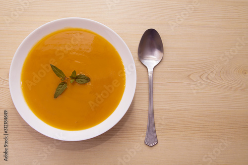 vegetable and carrot soup on background