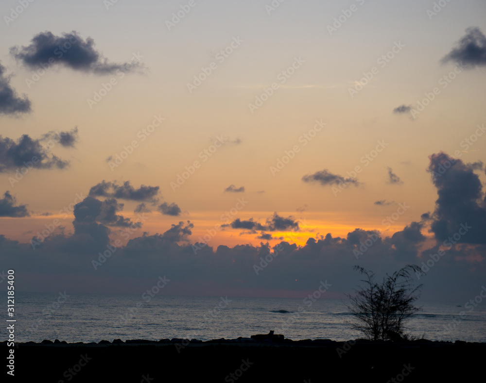 Panorama of sunset at beach with blue and orange color background,soft focus