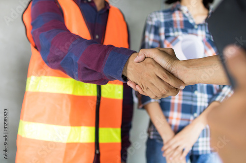 engineer shake hand with building contractor