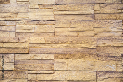 Background tiles facing irregular rectangular shape light sand color. Design backgrounds texture construction.