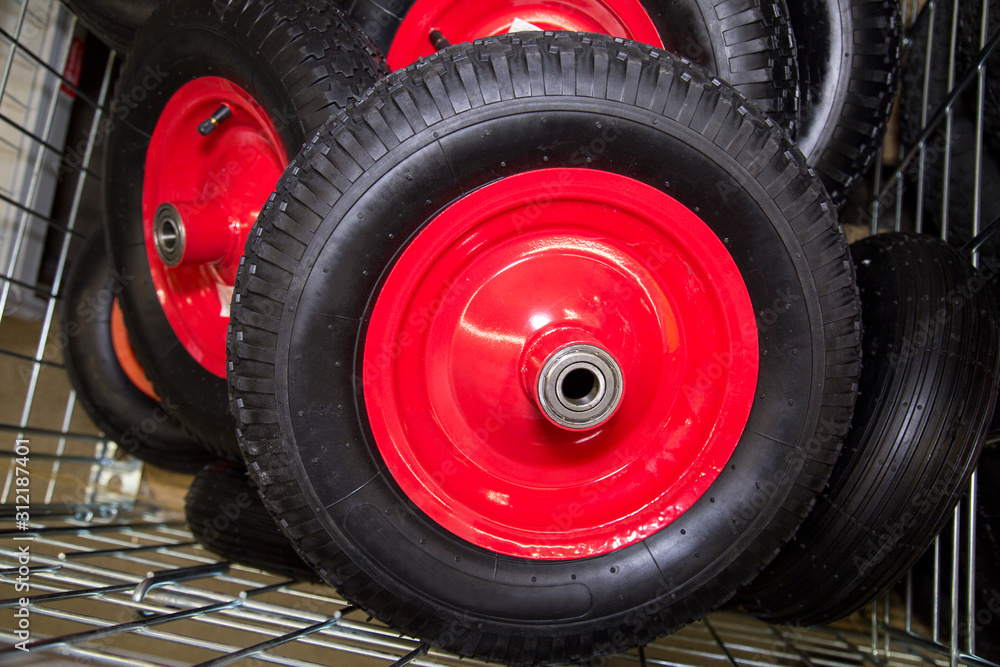 Inflatable wheels for construction wheelbarrows black red lying in a metal basket. Construction, repair, agricultural tools. Inflatable wheels for construction wheelbarrows black red lying in a metal basket. Construction, repair, agricultural tools.