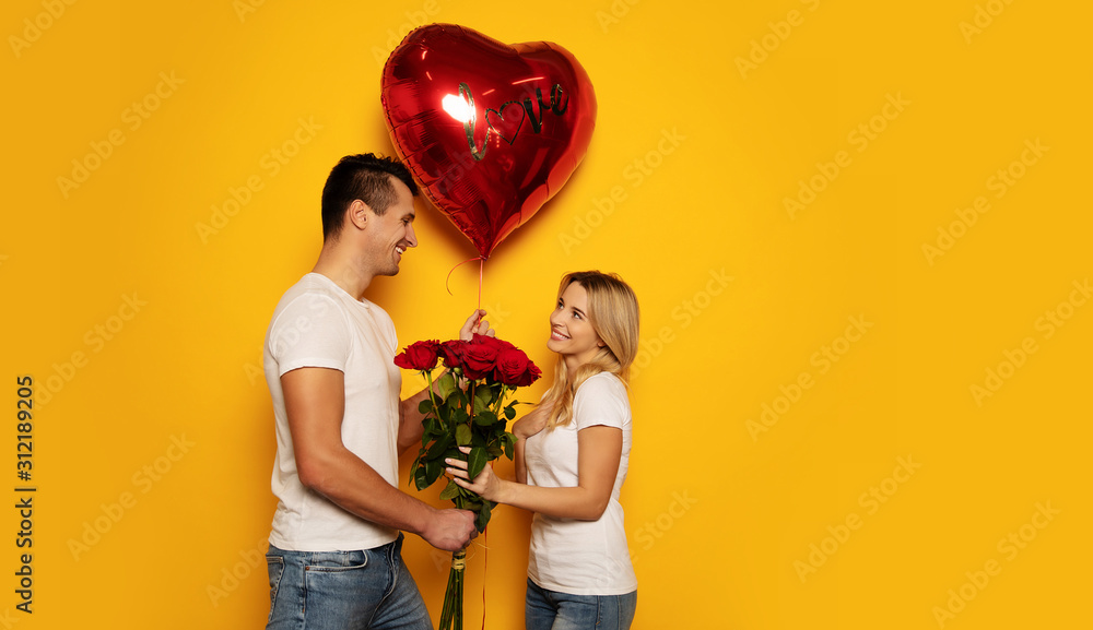 You’re my Valentine. A man is presenting a big red heart-shaped balloon and a bouquet of roses to his significant other, while she is giving him a radiant smile in return. You’re my Valentine. A man is presenting a big red heart-shaped balloon and a bouquet of roses to his significant other, while she is giving him a radiant smile in return.