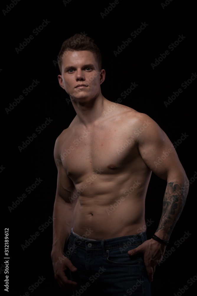portrait of a beautiful fashionable strong man with a bare torso