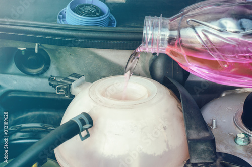 Car engine filling with coolant photo