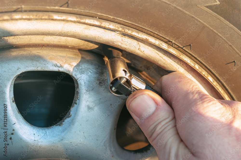 Car tire pressure check.closeup
