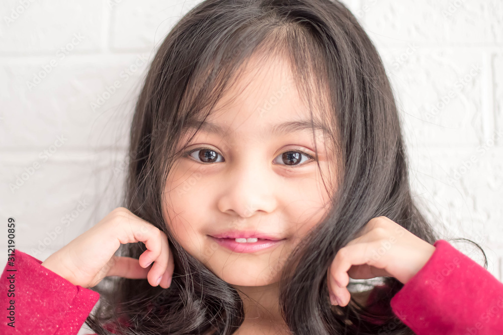 Fashion model and beauty look. Stylish girl with pretty face on grey background. Hairdresser, skincare, casual style. Beauty and kid fashion with healthy hair. Little girl with long hair.