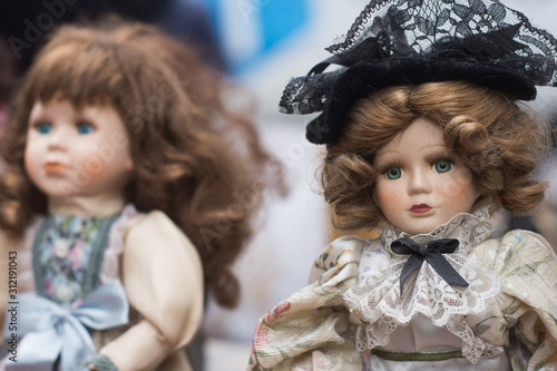 Photo Closeup of vintage dolls at flea market in the street
