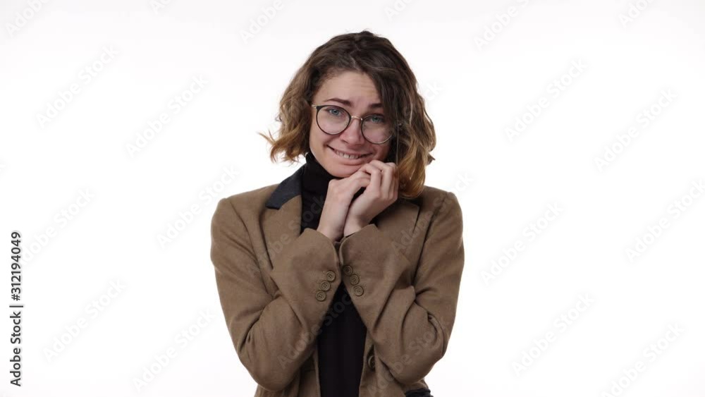 Portrait of positive female lovely looking to the camera - person being candid showing her affection and tender emotions over white background in slow motion. Concept of emotions Portrait of positive female lovely looking to the camera - person being candid showing her affection and tender emotions over white background in slow motion. Concept of emotions