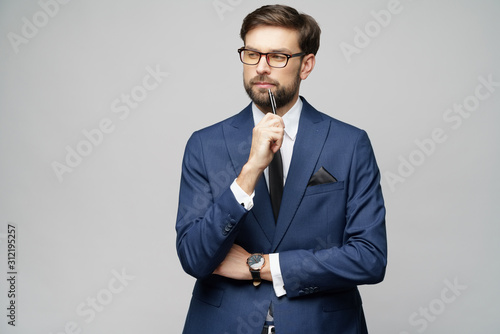 Studuo shot of thinking solving problem businessman wearing suit holding pen