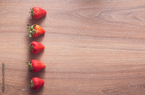 fresh strawberries on the brown wooden table