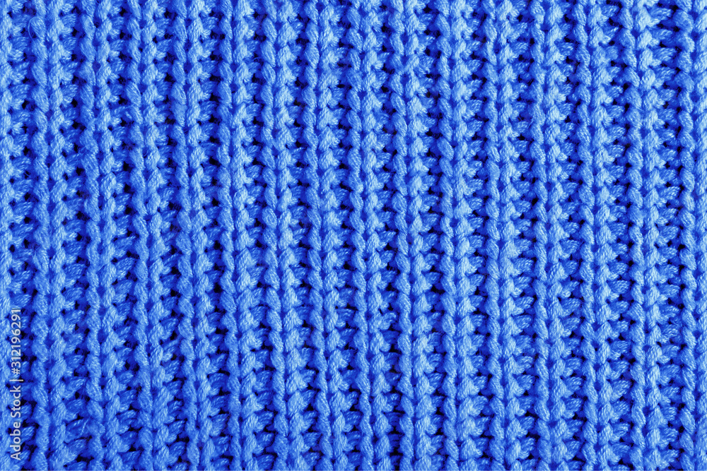 Color 2020 classic blue. Dark blue texture of a large knit sweater. Knitted scarf background, winter cozy textile background
