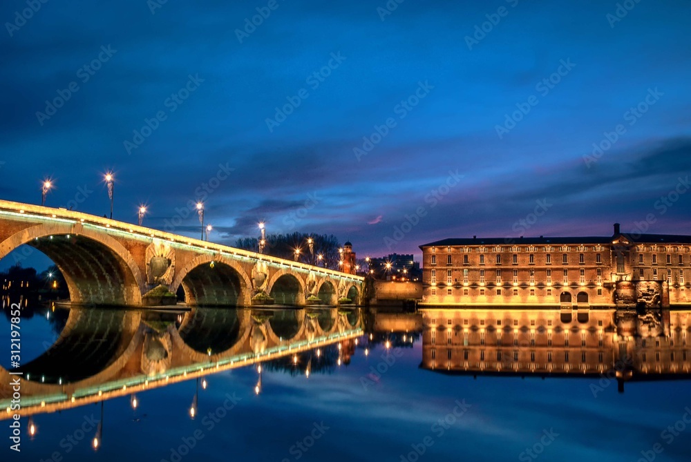 A panoramic view of the Pont Neuf bridge spanning the Garonne River in the heart of Toulouse, France