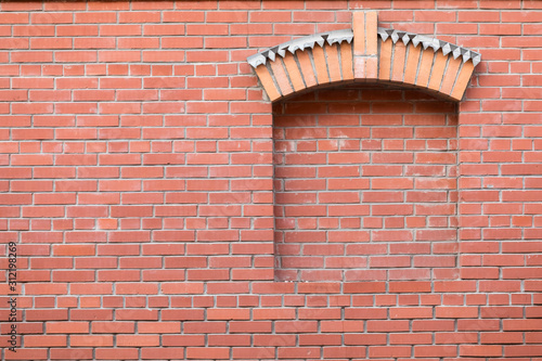 Photos Red brick wall with window opening and figurative visor