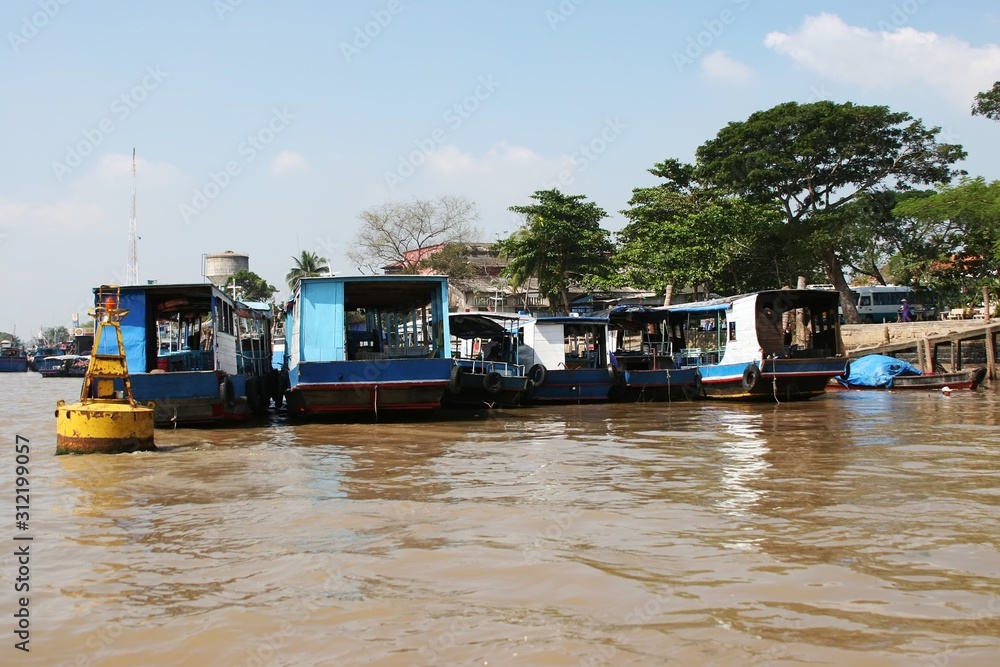 Rows of boats berthed at the Mekong riverbank in the Mekong Delta, Vietnam