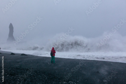 Photographer photographing the ocean during a storm in Iceland. long exposure