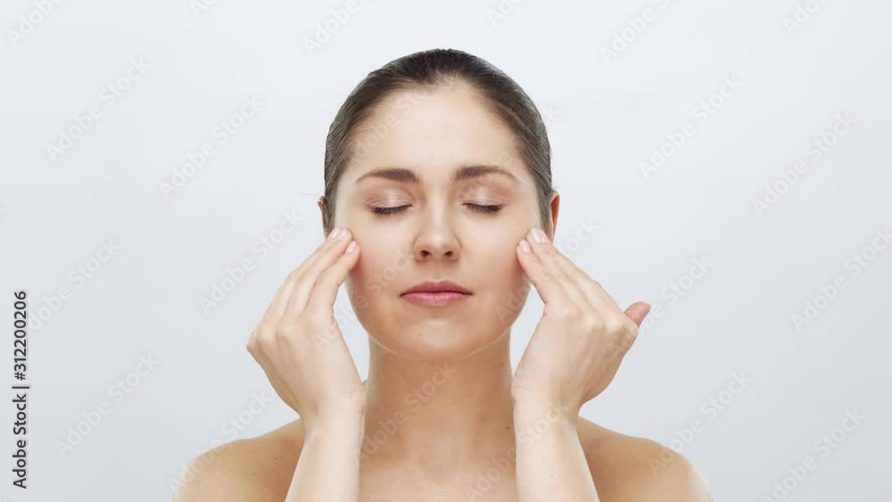 Studio portrait of young, beautiful and natural blond woman applying skin care cream. Face lifting, cosmetics and make-up. Studio portrait of young, beautiful and natural blond woman applying skin care cream. Face lifting, cosmetics and make-up.