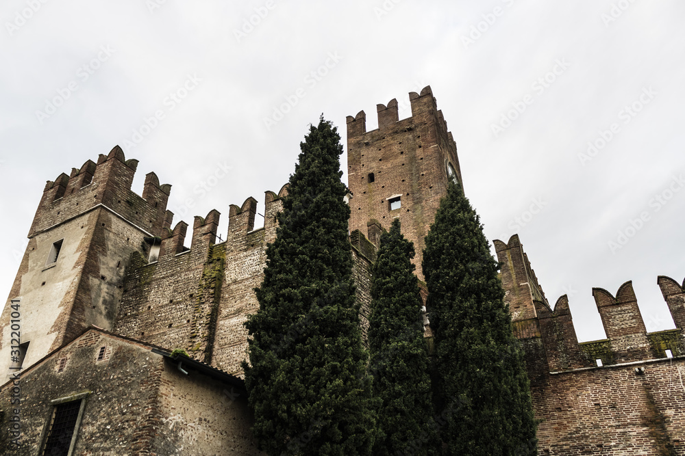 Beautiful Medieval castle in Villafranca di Verona in Italy, old castle towers view with the cypress trees - Image