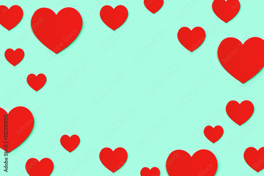Frame made of red decorative hearts on a blue background.
