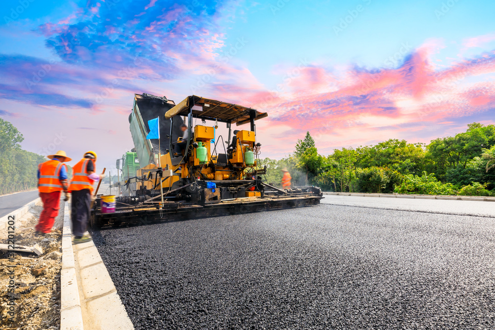 Construction site is laying new asphalt road pavement,road construction workers and road construction machinery scene. Construction site is laying new asphalt road pavement,road construction workers and road construction machinery scene.