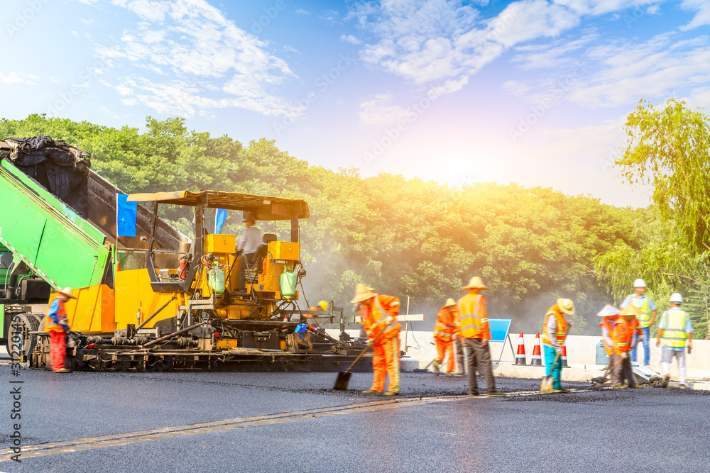 Construction site is laying new asphalt road pavement,road construction workers and road construction machinery scene. Construction site is laying new asphalt road pavement,road construction workers and road construction machinery scene.