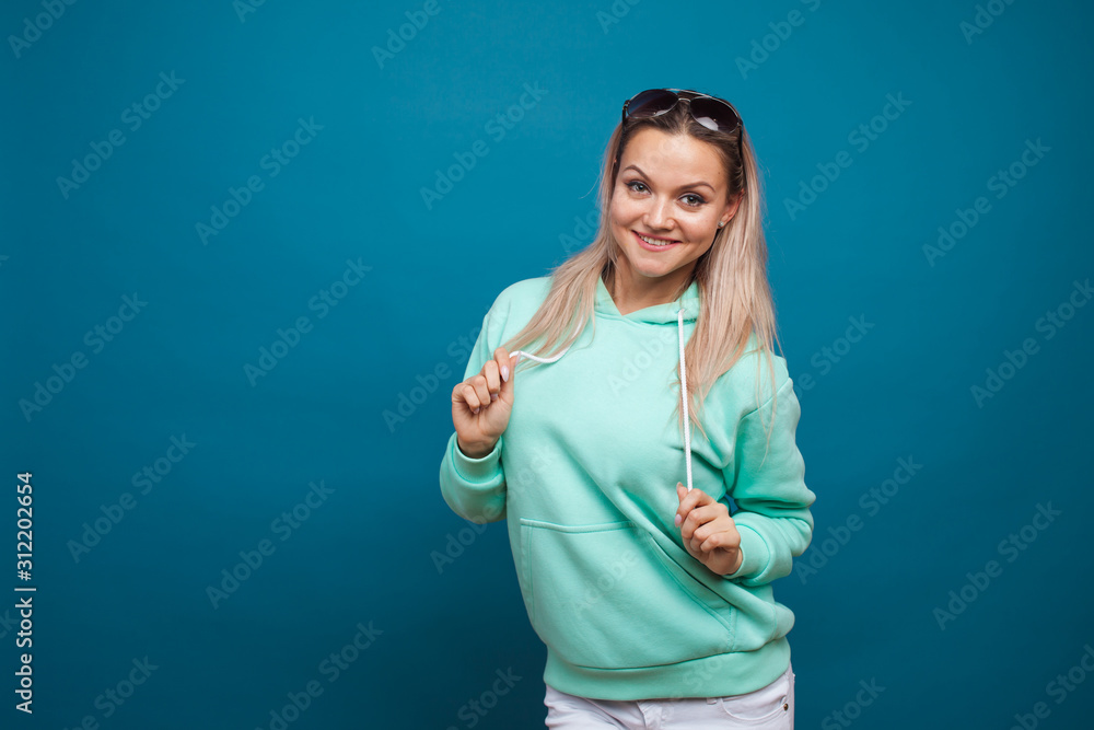 Fashionable young girl in blue hoodie. young woman Fashionable young girl in blue hoodie. young woman